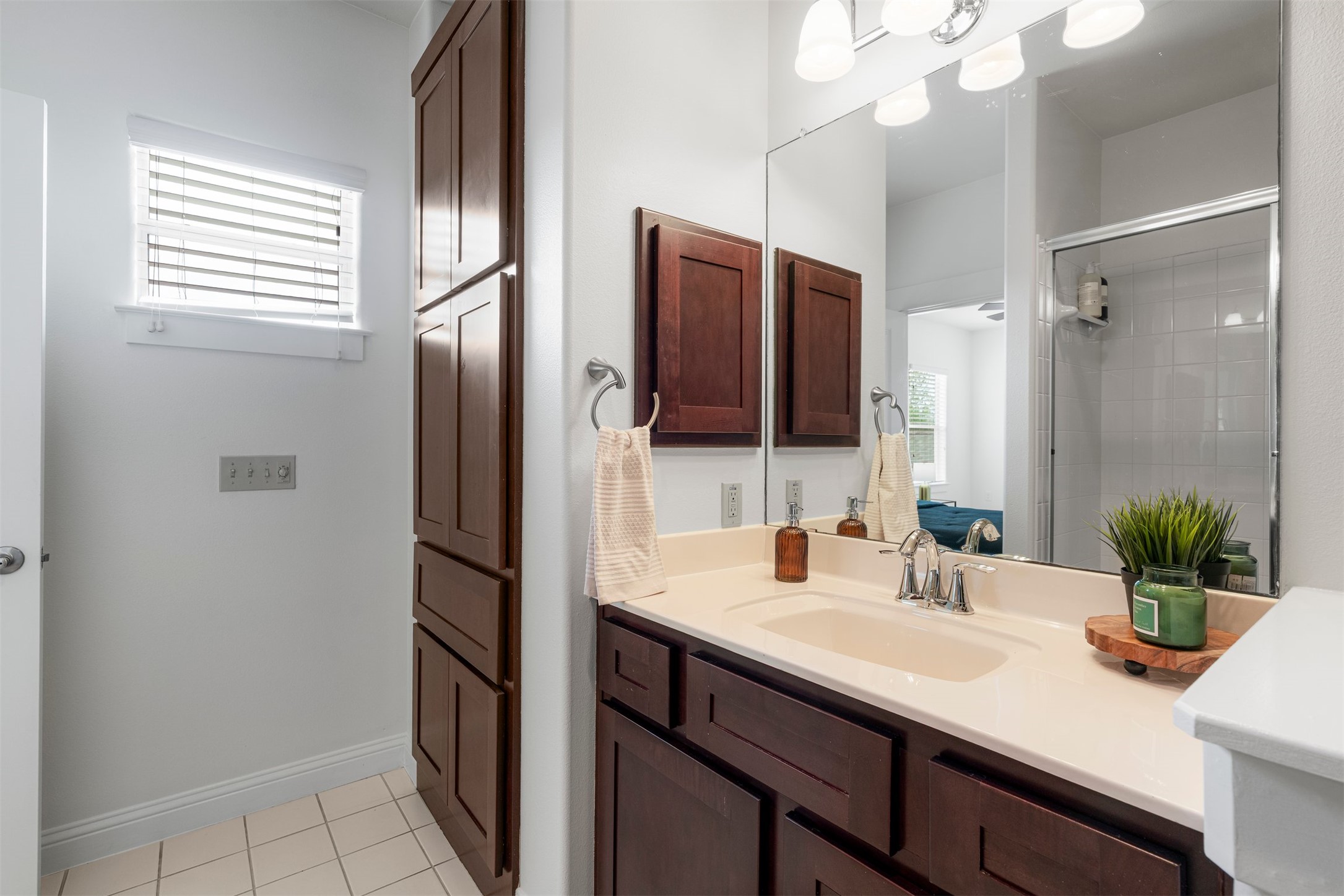 4216 Threadgill Street Austin, TX 78723 - Photo 35 of 40 a bathroom with a sink a potted plant and a mirror