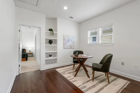 a work room with furniture and wooden floor