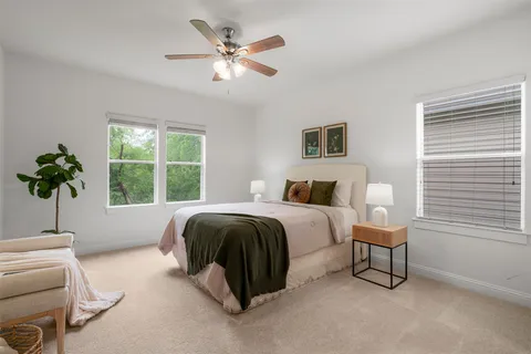 a spacious bedroom with a bed and a window