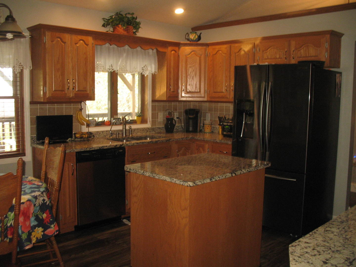 3158 Deerfield Road Clinton, IL 61727 - Photo 22 of 61 a kitchen with a sink a refrigerator and cabinets
