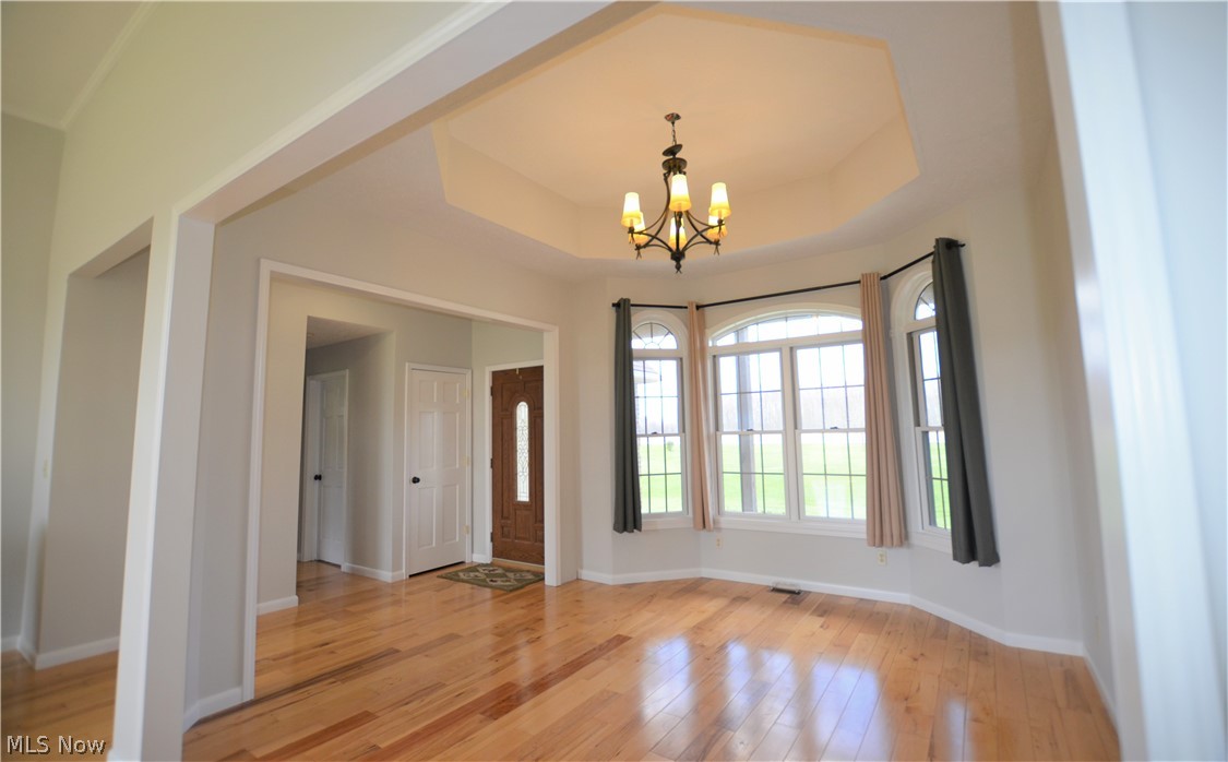 17871 Rowell Road Wellington, OH 44090 - Photo 8 of 34 Dining room with trey ceiling, hickory floors