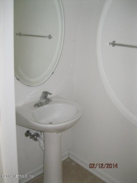 6700 Bowden Road, Unit 1605 Jacksonville, FL 32216 - Photo 3 of 9 a bathroom with a sink and mirror