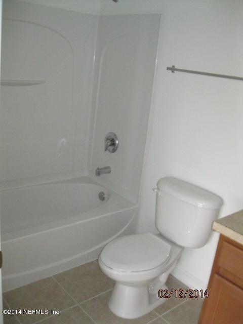 6700 Bowden Road, Unit 1605 Jacksonville, FL 32216 - Photo 8 of 9 a white toilet sitting next to a bath tub