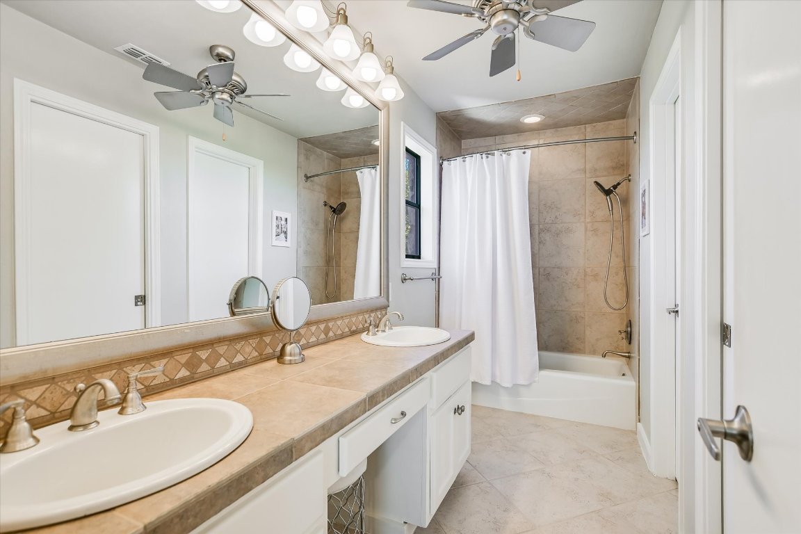 8200 Neely Drive, Unit 206 Austin, TX 78759 - Photo 11 of 26 a bathroom with a granite countertop sink mirror bathtub and shower