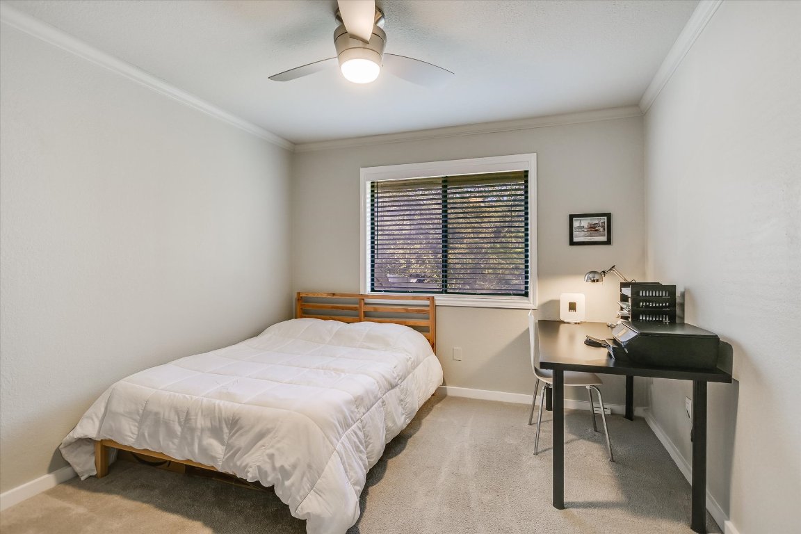 8200 Neely Drive, Unit 206 Austin, TX 78759 - Photo 12 of 26 a bedroom with a bed table chair and a window