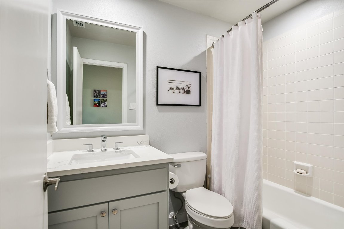 8200 Neely Drive, Unit 206 Austin, TX 78759 - Photo 13 of 26 a bathroom with a sink vanity mirror and toilet