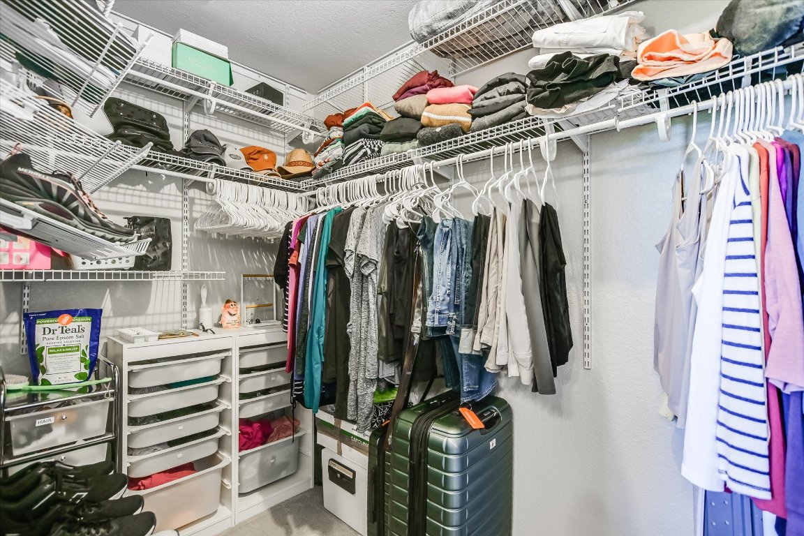 8200 Neely Drive, Unit 206 Austin, TX 78759 - Photo 14 of 26 a view of walk in closet with clothes and shoes