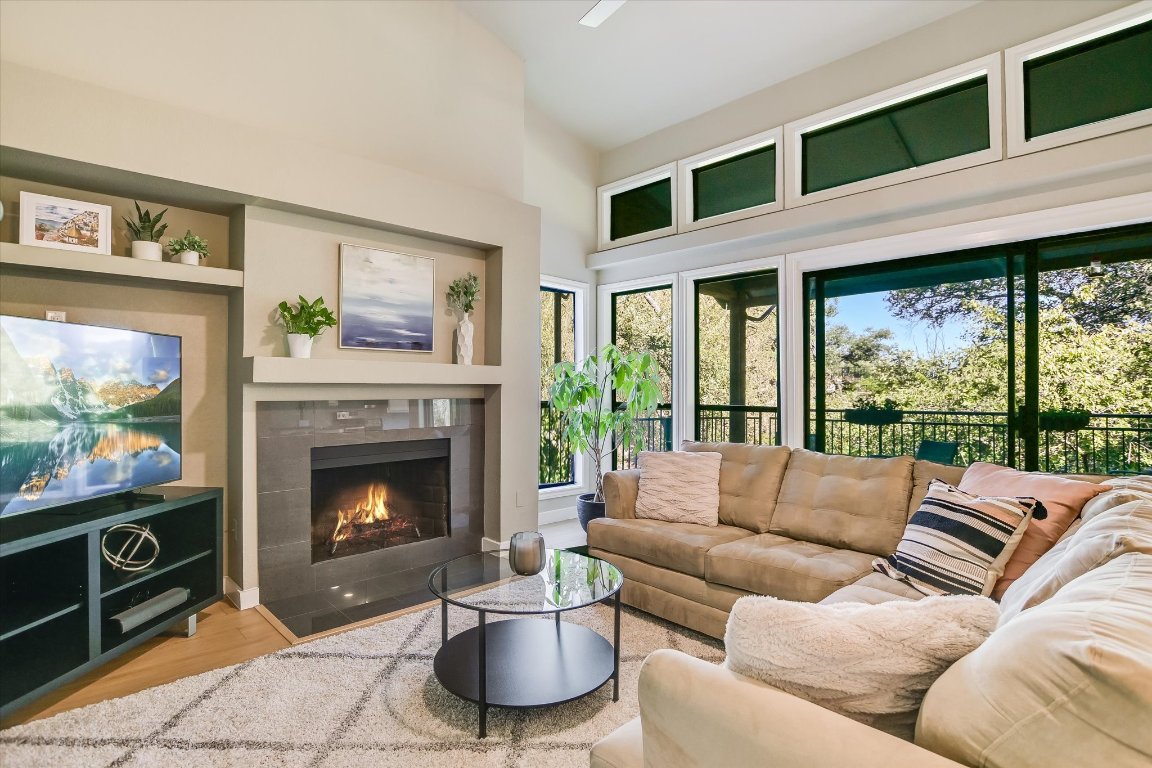 8200 Neely Drive, Unit 206 Austin, TX 78759 - Photo 2 of 26 a living room with furniture a fireplace and a flat screen tv