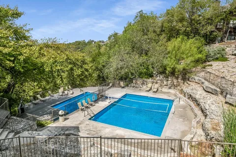 a view of a backyard with plants and a lake view