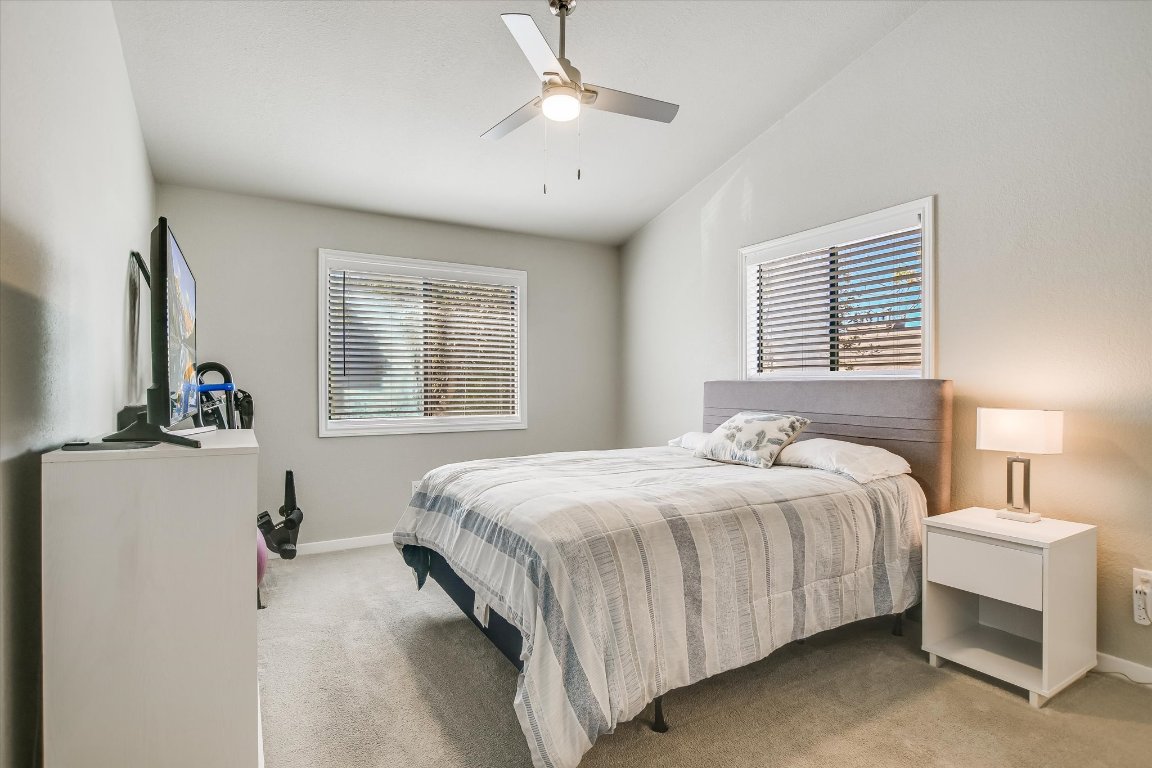 8200 Neely Drive, Unit 206 Austin, TX 78759 - Photo 10 of 26 a bedroom with a bed and a chandelier