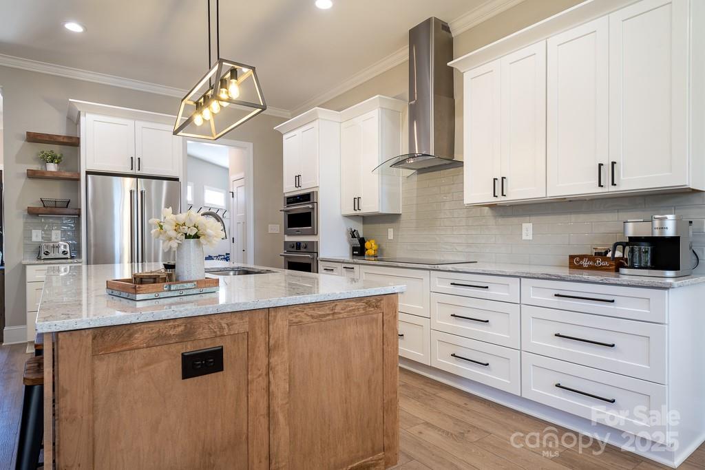787 Morrison Farm Road Troutman, NC 28166 - Photo 11 of 24 a kitchen with cabinets appliances a sink and a counter top space