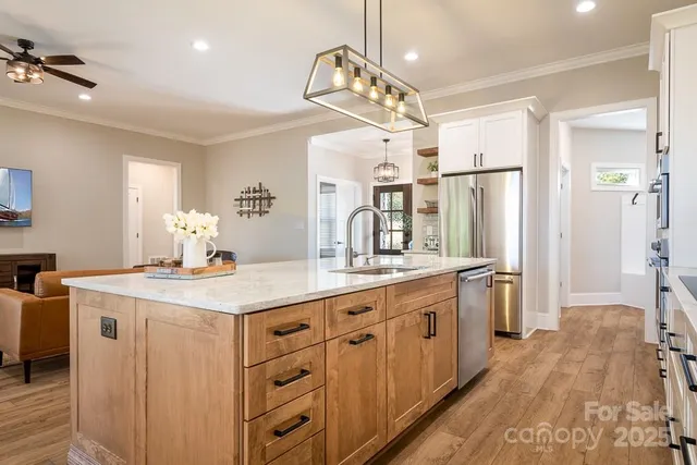 a kitchen with stainless steel appliances a sink stove and refrigerator
