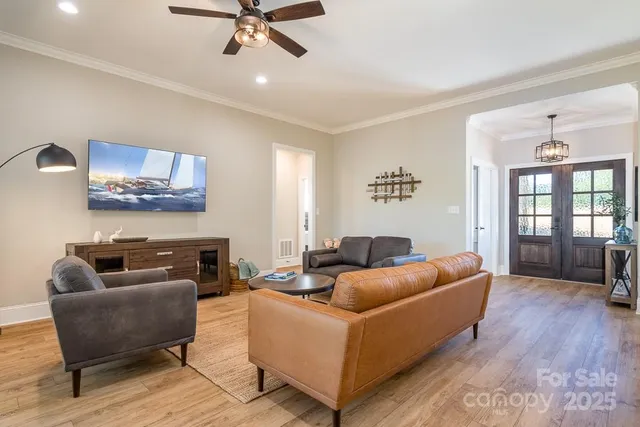 a living room with furniture and a ceiling fan
