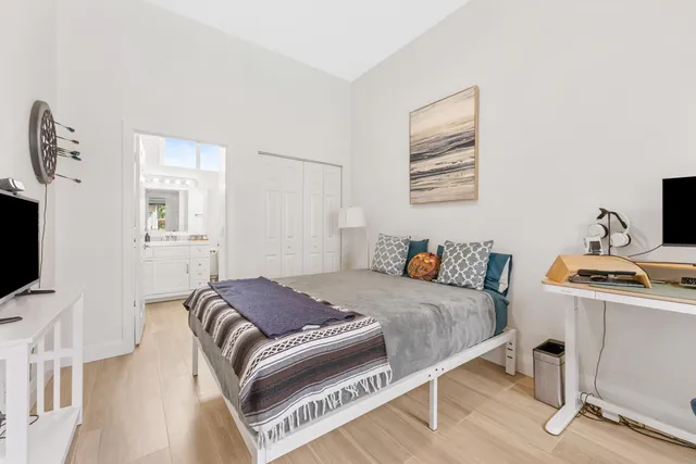 a bedroom with a bed and a flat screen tv