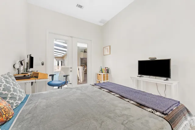 a bedroom with a bed and a flat screen tv