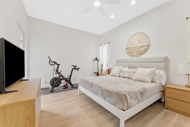 a bathroom with a double vanity sink toilet mirror and bathtub