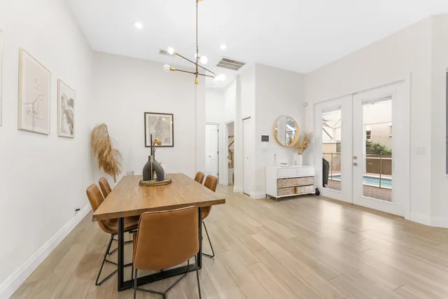 a living room with furniture and potted plants
