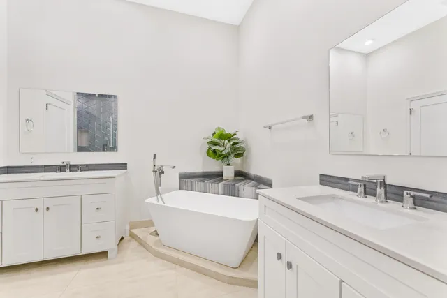 a spacious bedroom with a bed a couch and a window