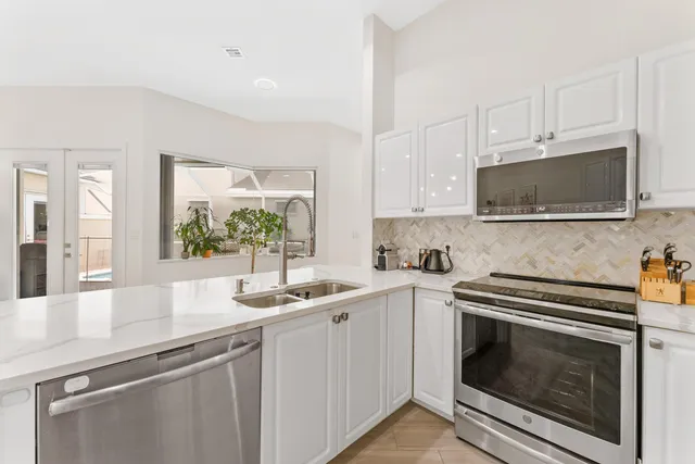 a living room with furniture and a dining table with kitchen view