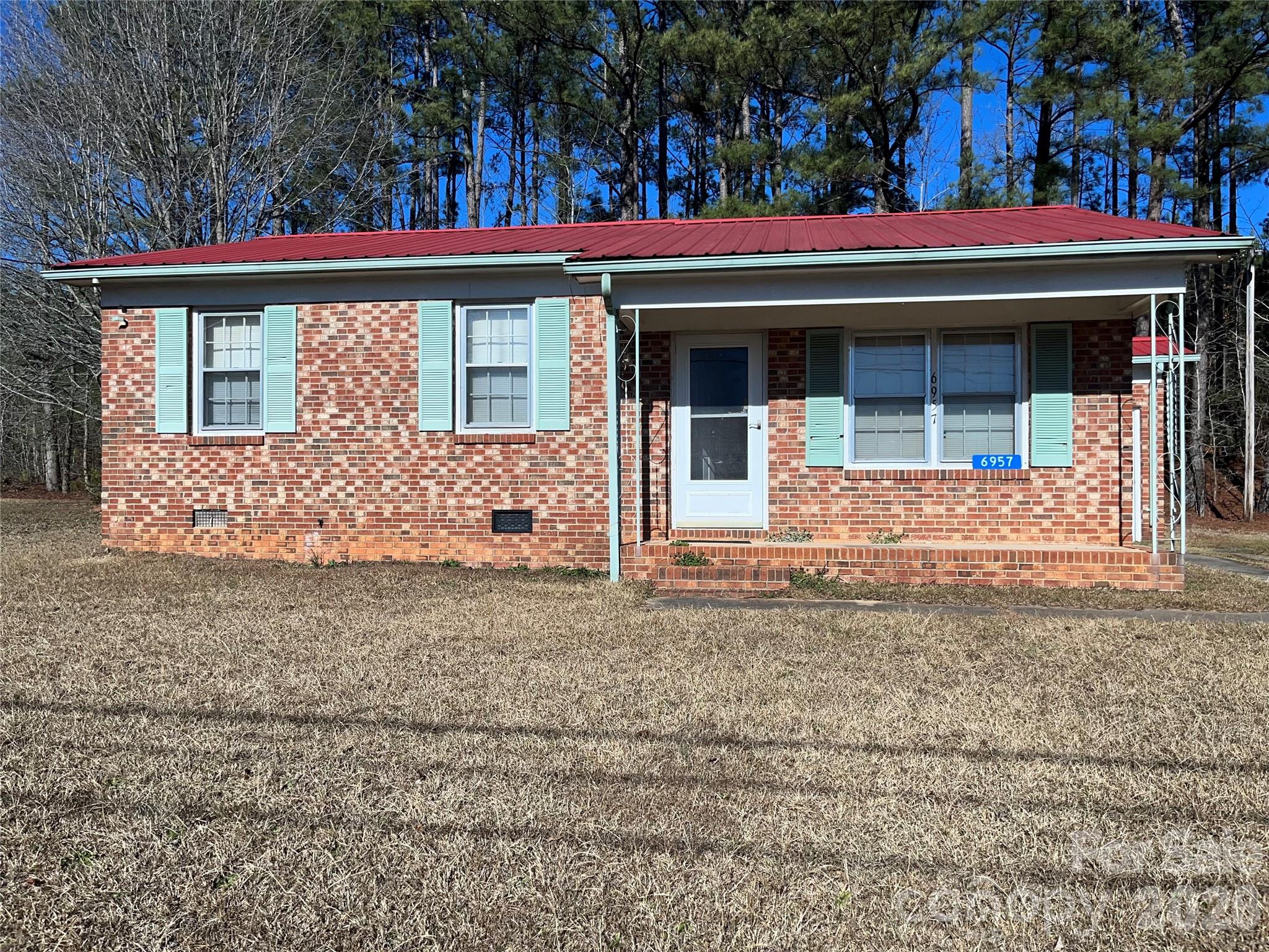 6957 Vintage Road Lilesville, NC 28091 - Photo 1 of 10 a front view of a house with garden