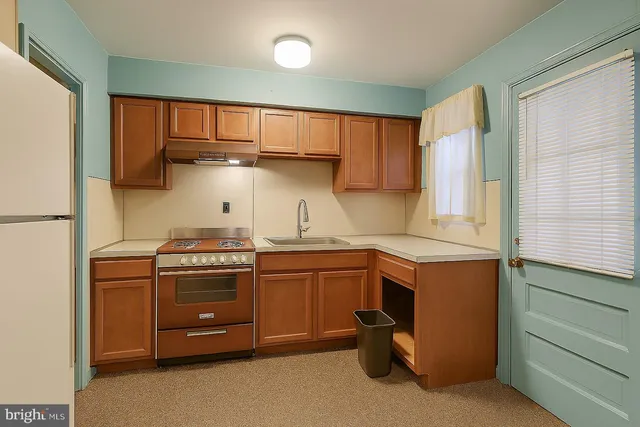 a kitchen with stainless steel appliances granite countertop a stove and a refrigerator