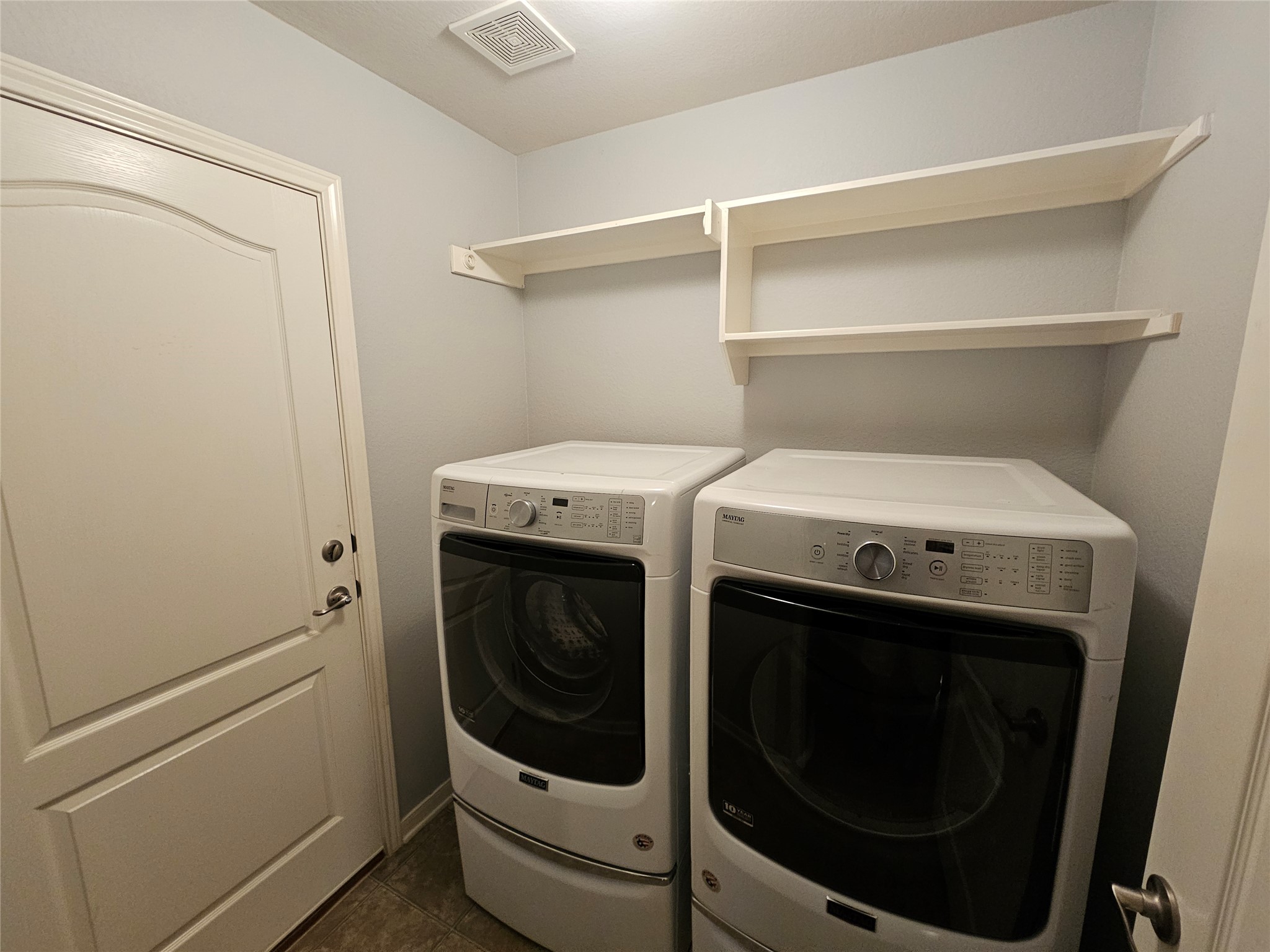 2035 Intrepid Drive Buda, TX 78610 - Photo 22 of 26 A dedicated laundry space offers convenience with ample storage and modern appliances.