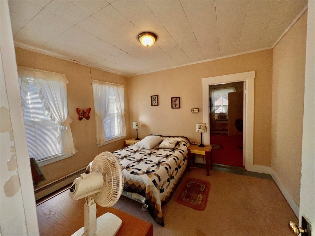 7 Myrtle Street Middleboro, MA 02346 - Photo 13 of 21 a bedroom with a bed and wooden floor