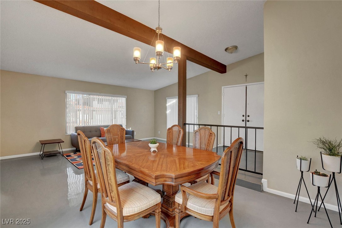 3215 Mountain Spring Road Las Vegas, NV 89146 - Photo 11 of 42 Dining room with concrete floors and a chandelier