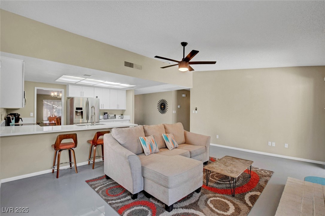 3215 Mountain Spring Road Las Vegas, NV 89146 - Photo 13 of 42 Living area with ceiling fan and finished concrete flooring
