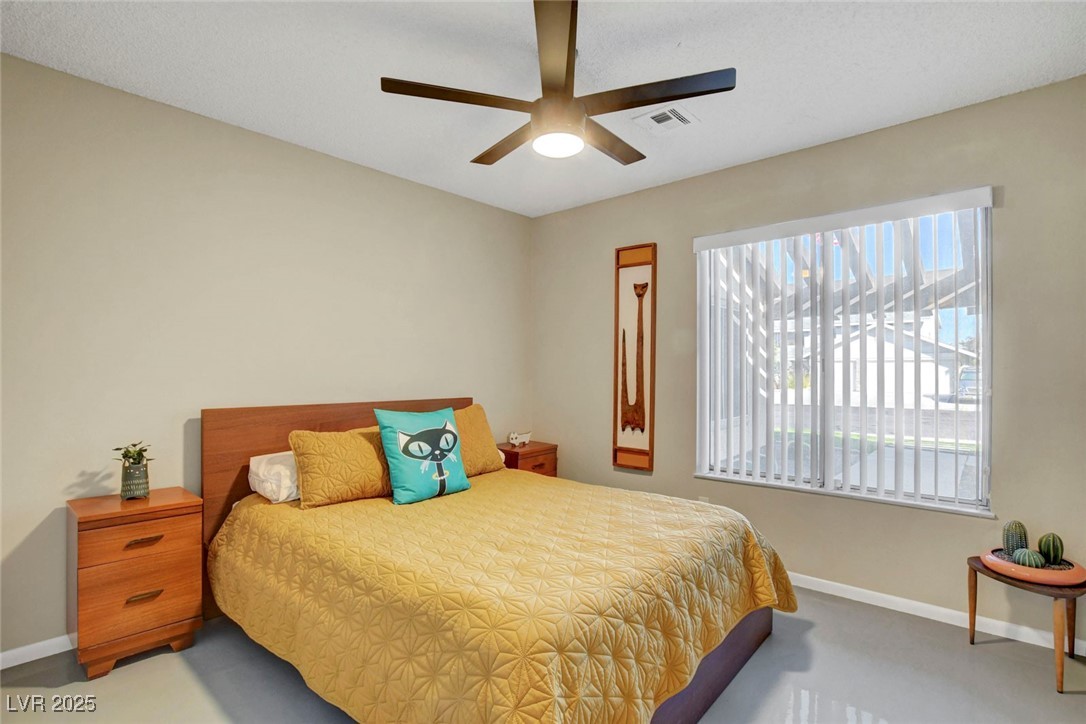 3215 Mountain Spring Road Las Vegas, NV 89146 - Photo 21 of 42 Bedroom featuring a ceiling fan and carpet