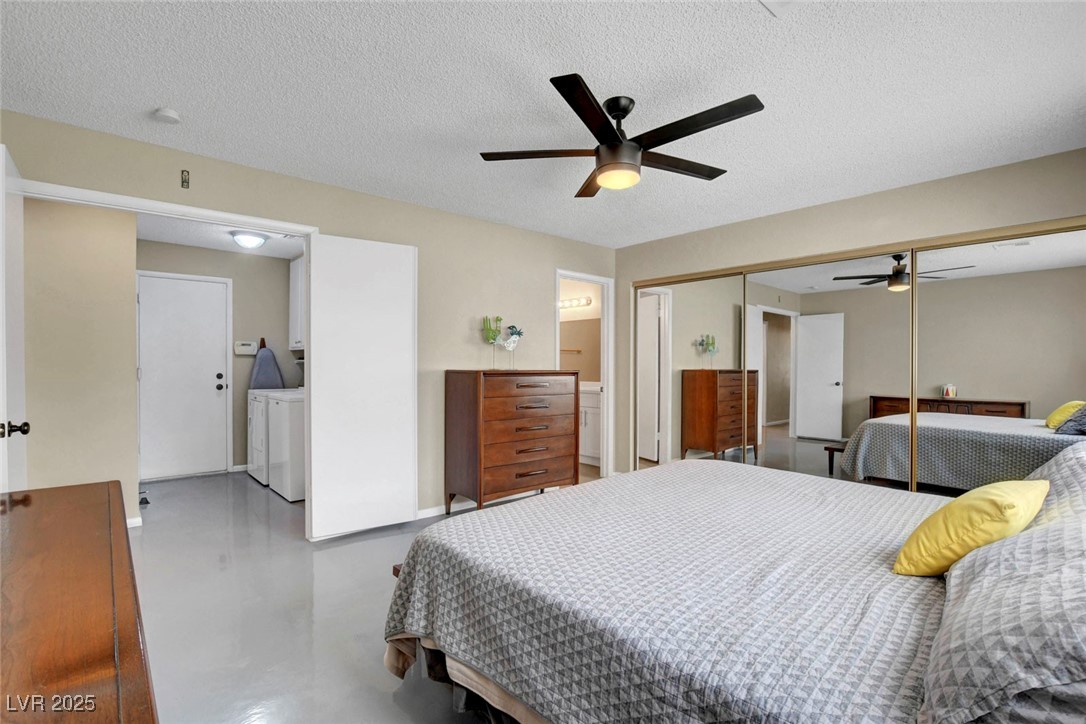3215 Mountain Spring Road Las Vegas, NV 89146 - Photo 28 of 42 Bedroom with a closet, concrete flooring, ceiling fan, a textured ceiling, and separate washer and dryer