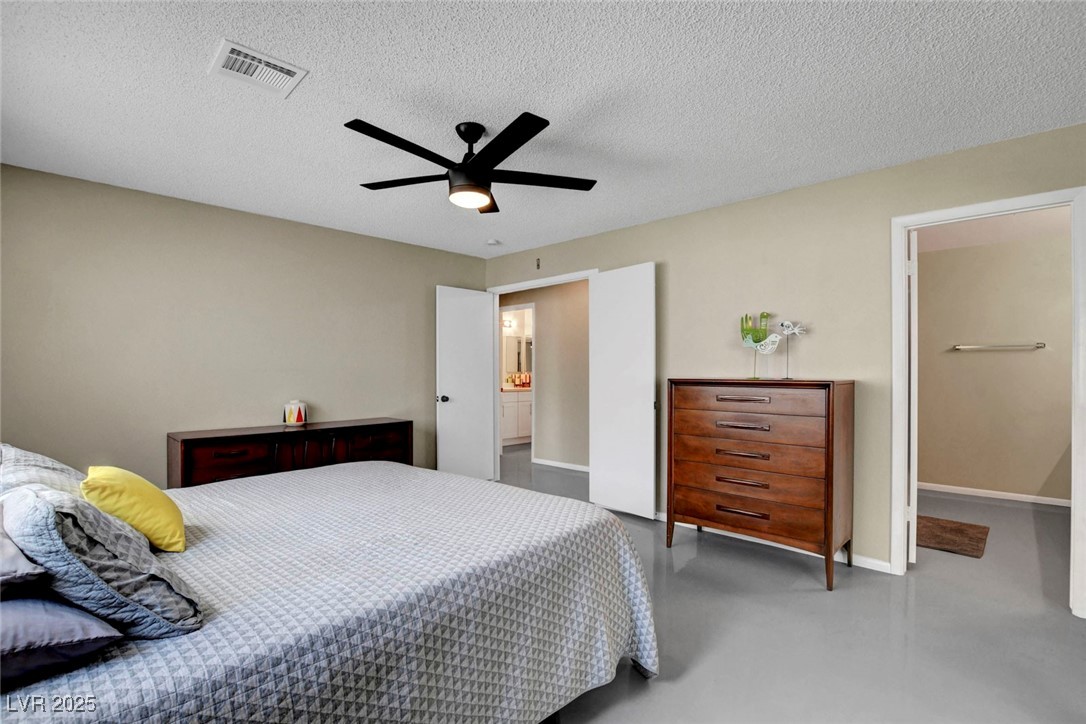 3215 Mountain Spring Road Las Vegas, NV 89146 - Photo 29 of 42 Bedroom with concrete flooring, ceiling fan, and a textured ceiling