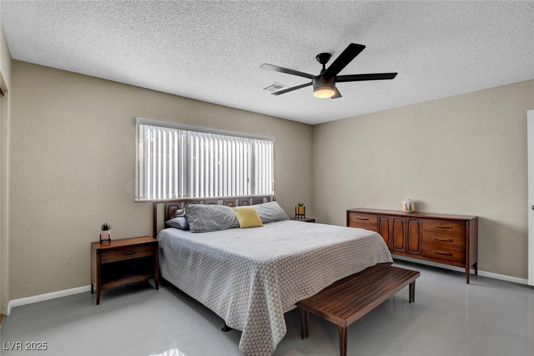 3215 Mountain Spring Road Las Vegas, NV 89146 - Photo 30 of 42 Bedroom featuring a ceiling fan, concrete flooring, a textured ceiling, and a closet