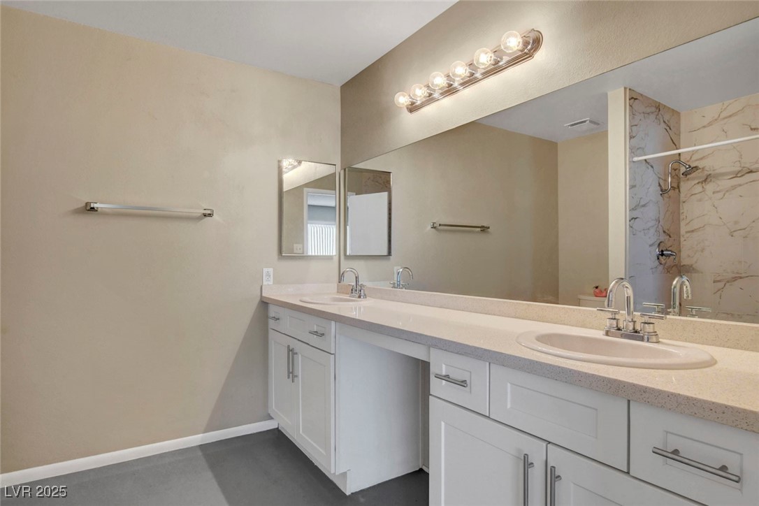 3215 Mountain Spring Road Las Vegas, NV 89146 - Photo 32 of 42 Bathroom featuring double vanity and a marble finish shower