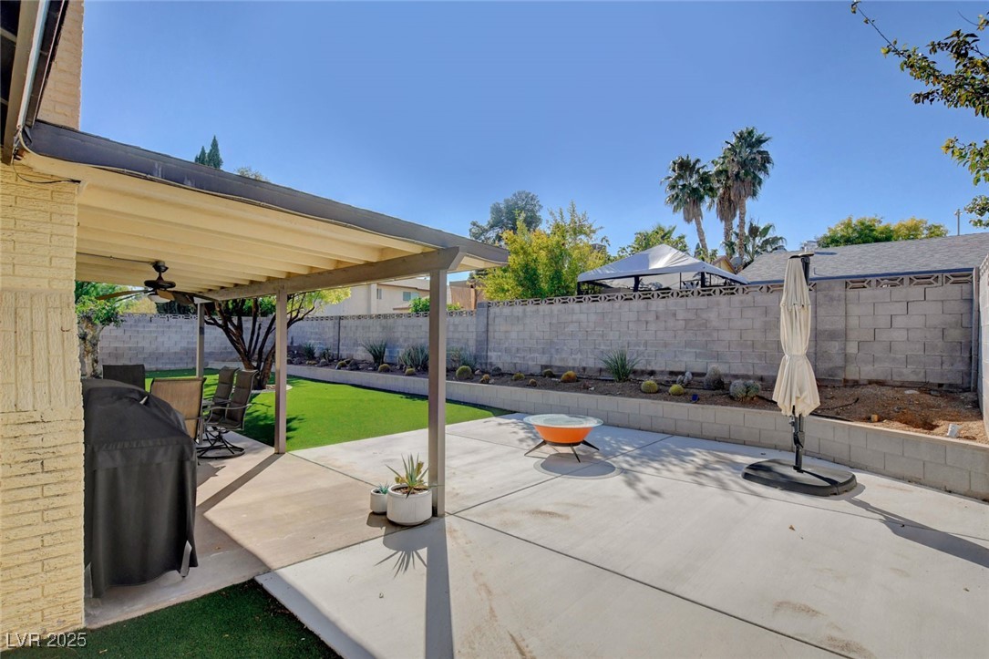 3215 Mountain Spring Road Las Vegas, NV 89146 - Photo 35 of 42 Fenced backyard featuring a patio area, grilling area, and ceiling fan
