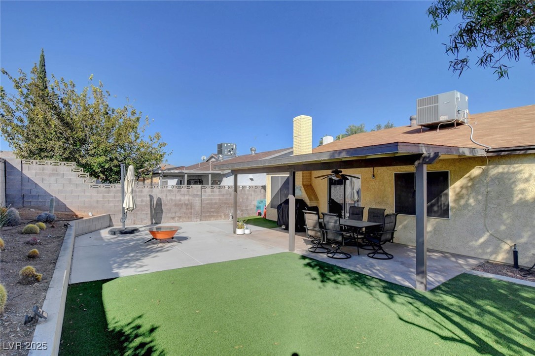 3215 Mountain Spring Road Las Vegas, NV 89146 - Photo 40 of 42 Rear view of property featuring a patio, a fenced backyard, stucco siding, a ceiling fan, and a chimney