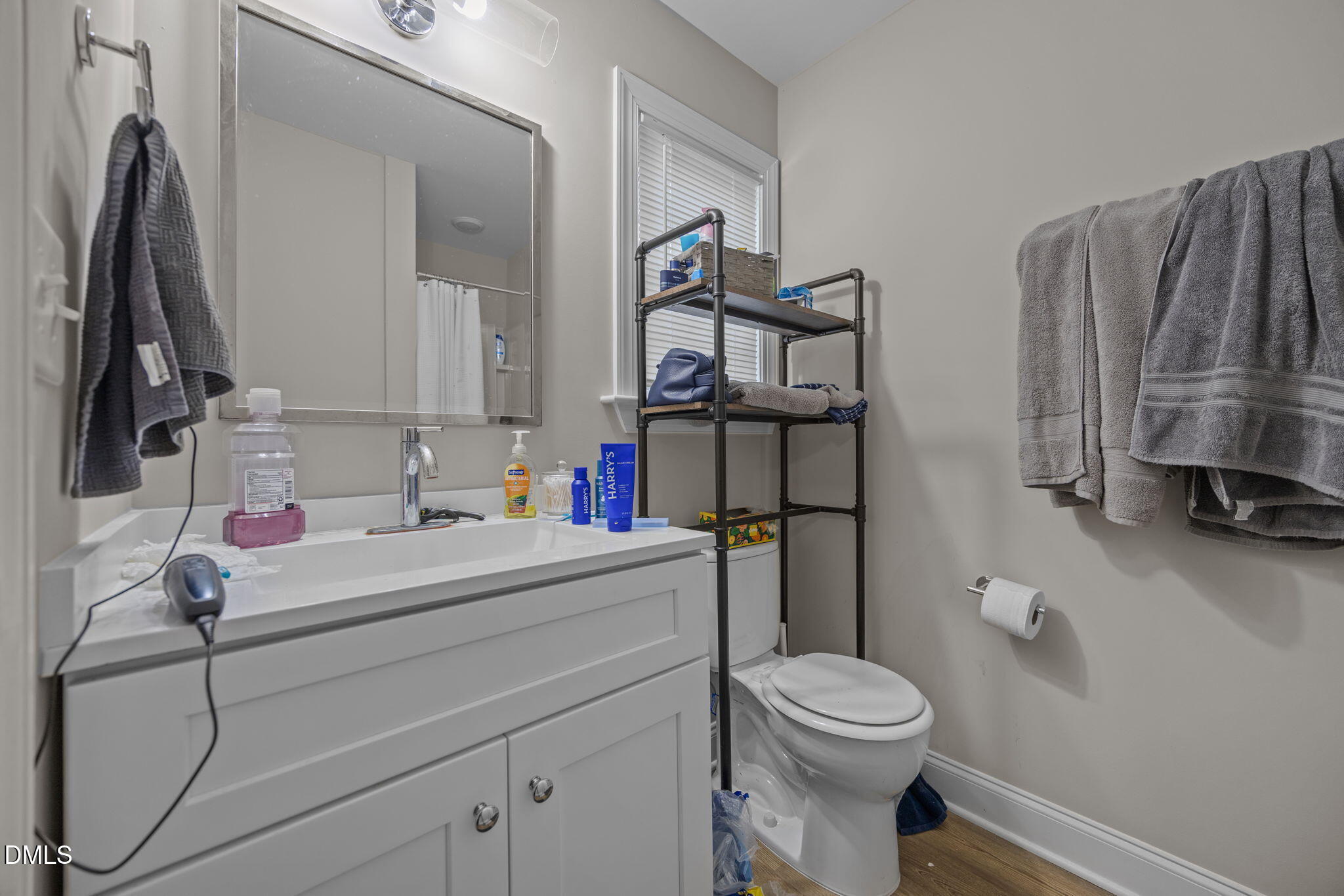 1508 Gorman Street, Unit 102 Raleigh, NC 27606 - Photo 11 of 25 a bathroom with a sink a toilet and a mirror