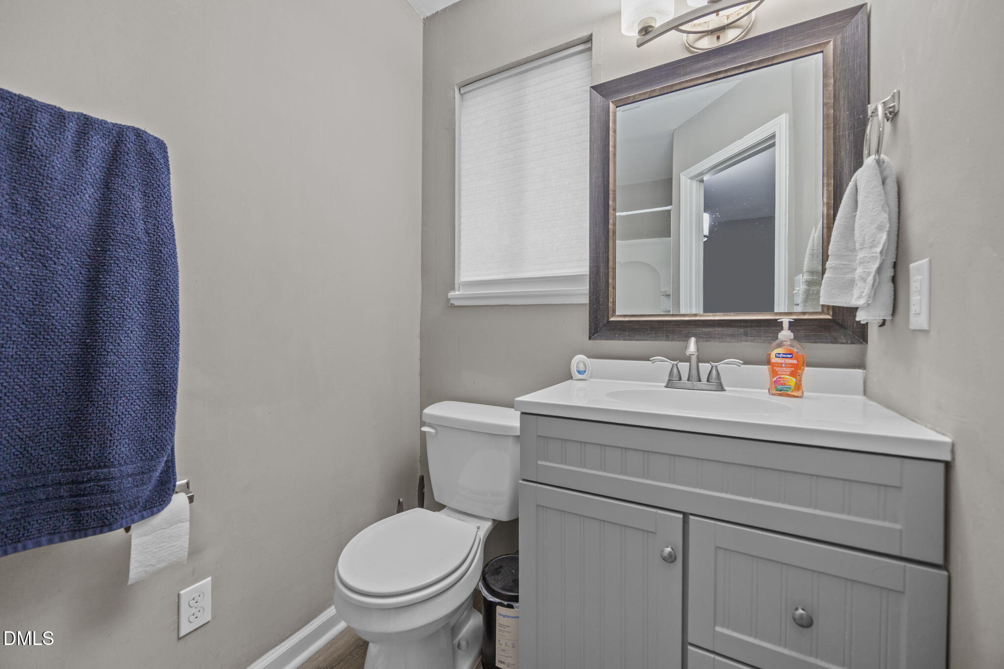 1508 Gorman Street, Unit 102 Raleigh, NC 27606 - Photo 15 of 25 a bathroom with a toilet sink and mirror