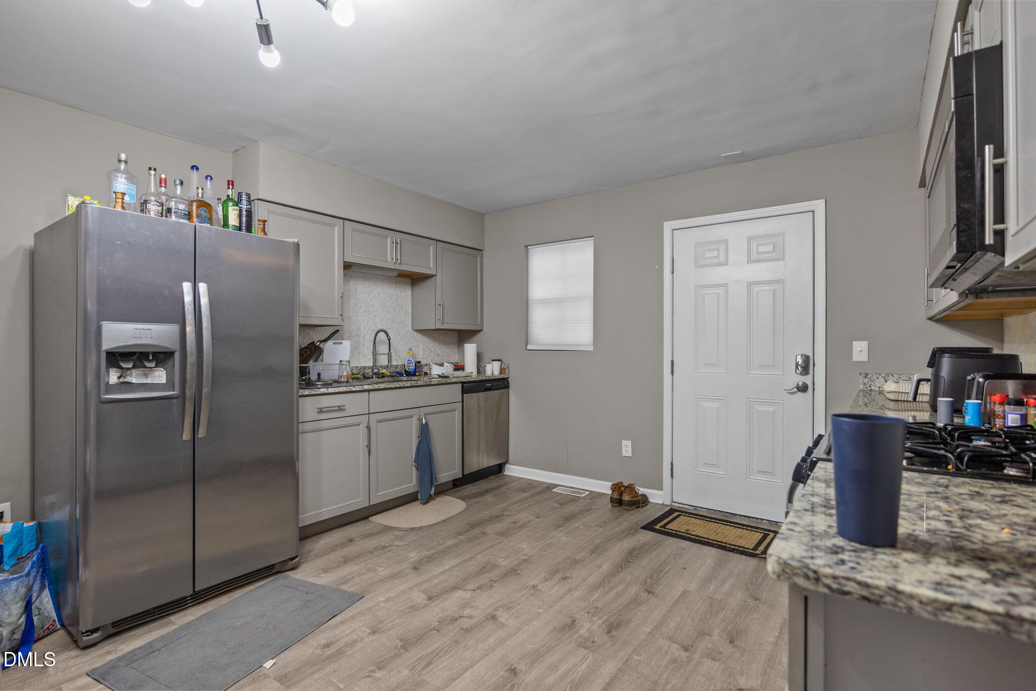1508 Gorman Street, Unit 102 Raleigh, NC 27606 - Photo 2 of 25 a kitchen with stainless steel appliances granite countertop a refrigerator and a sink