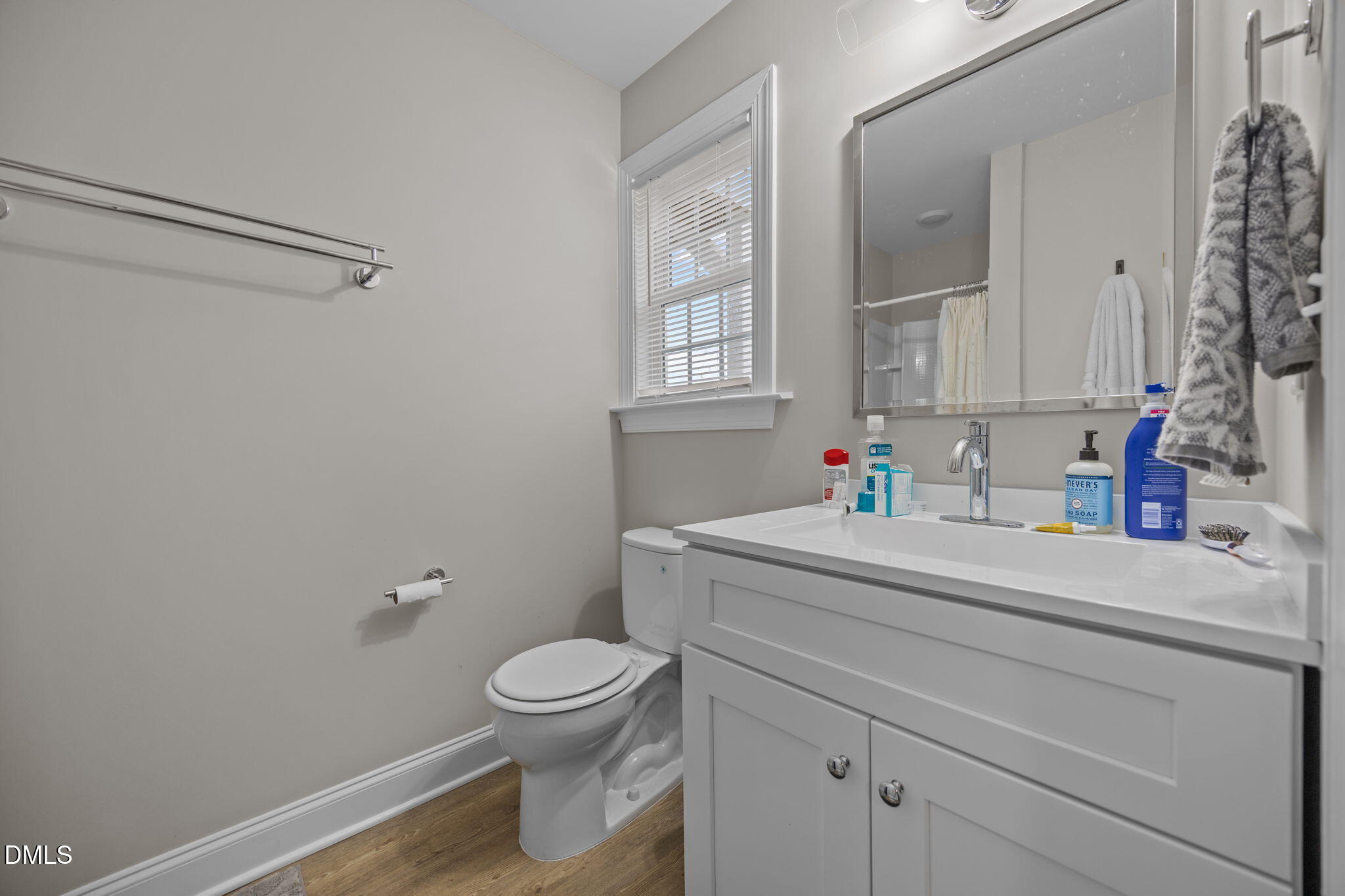 1508 Gorman Street, Unit 102 Raleigh, NC 27606 - Photo 23 of 25 a bathroom with a sink mirror vanity and toilet