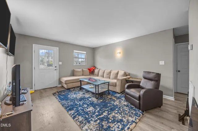 a living room with furniture a ceiling fan and a window