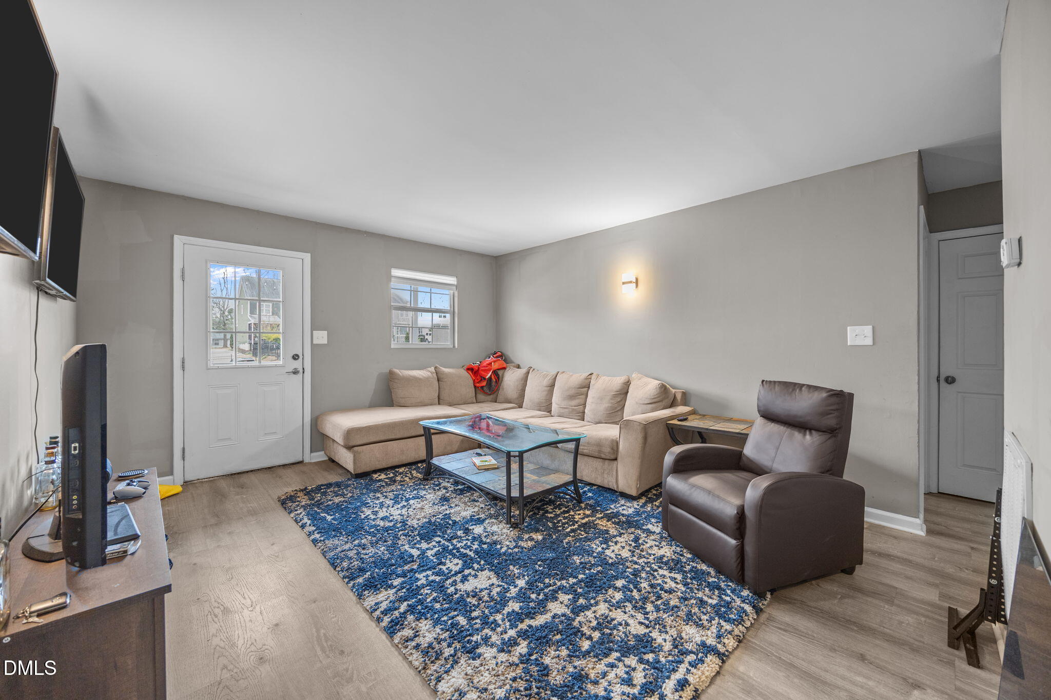 1508 Gorman Street, Unit 102 Raleigh, NC 27606 - Photo 4 of 25 a living room with furniture wooden floor and a flat screen tv