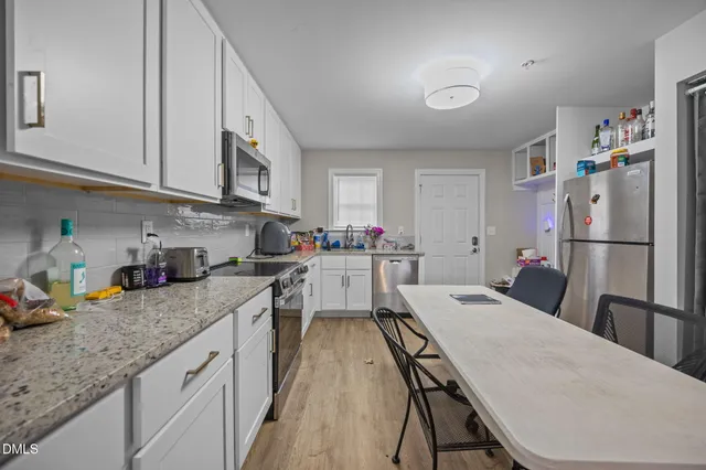 a bathroom with a sink a toilet and vanity