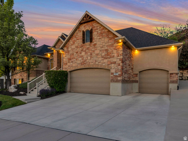 577 South Ridge Top Lane East North Salt Lake, UT 84054 - Photo 44 of 57 Elegant front elevation featuring mature landscaping, custom stonework, and a welcoming approach.