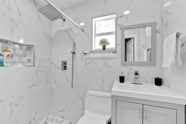 a bathroom with a sink toilet and shower