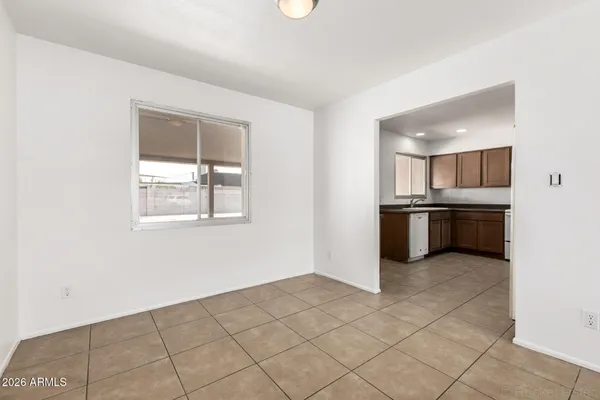 a kitchen with a refrigerator and a stove top oven