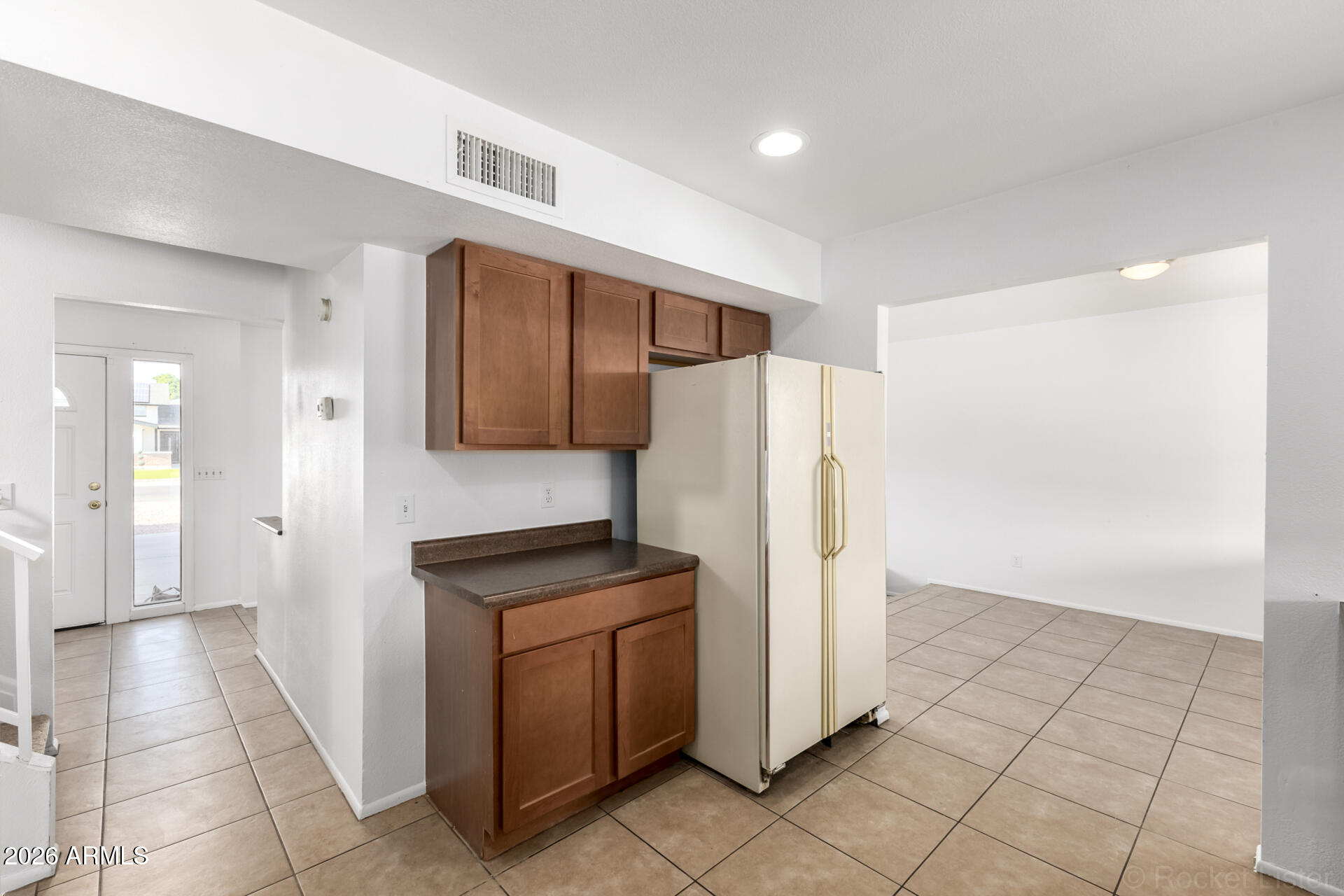 4617 South Grandview Avenue Tempe, AZ 85282 - Photo 12 of 31 a kitchen with a refrigerator and a stove top oven