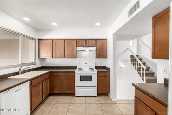 a kitchen with cabinets and stainless steel appliances