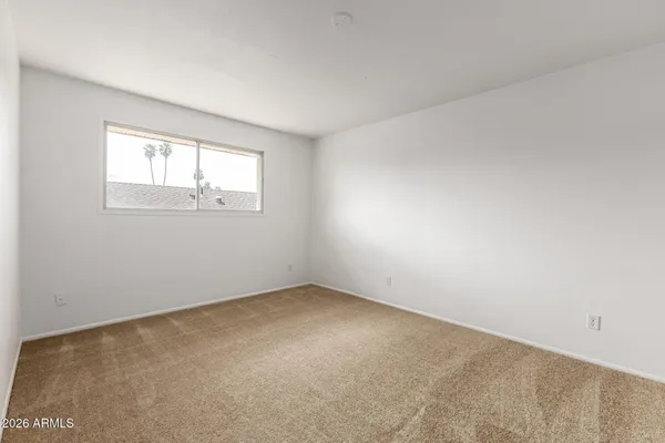 a view of an empty room and entryway