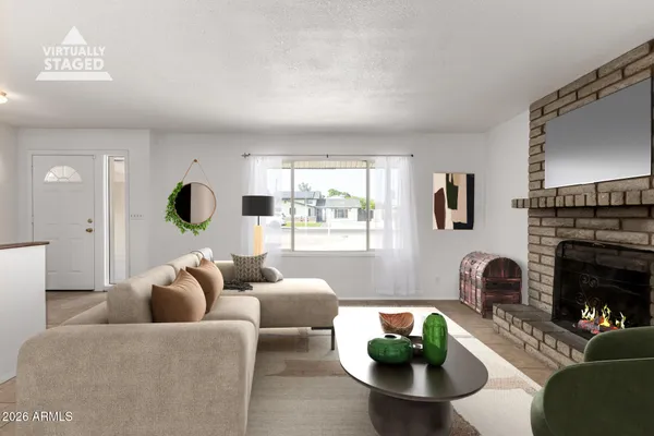 a living room with furniture a window and a fireplace